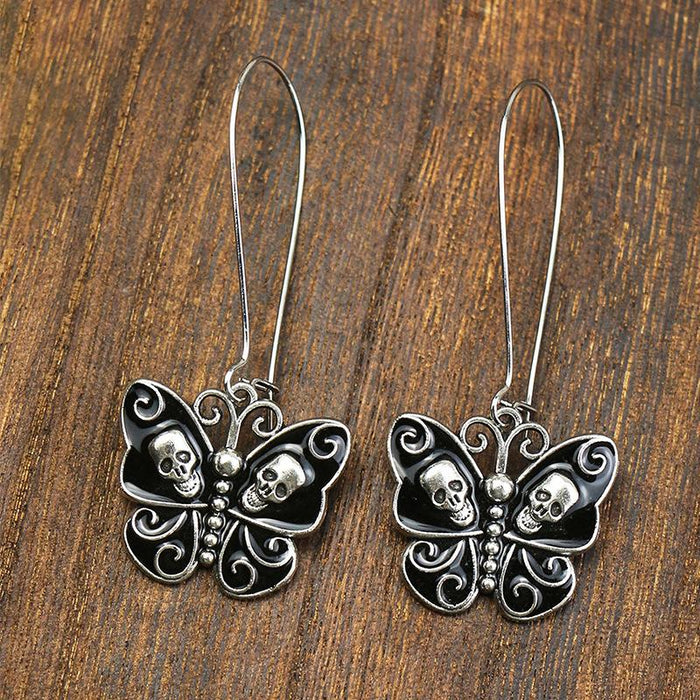 White Gold Black Oil Dripping Butterfly Alloy Skull Standing Ear Ornament